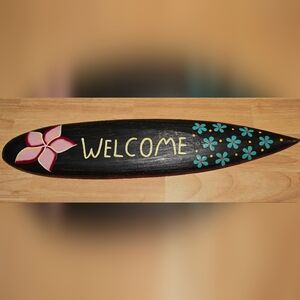 Dark Brown Surfboard Welcome Sign with Pink and Blue Flowers